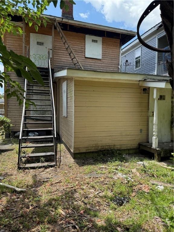 634 W 39th St, Savannah, GA 31415 - back of property featuring stairs and a chimney
