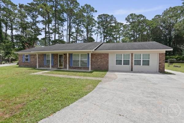 13609 Rockingham Ct, Savannah, GA 31419 - ranch-style house with concrete driveway, a front lawn, and brick siding