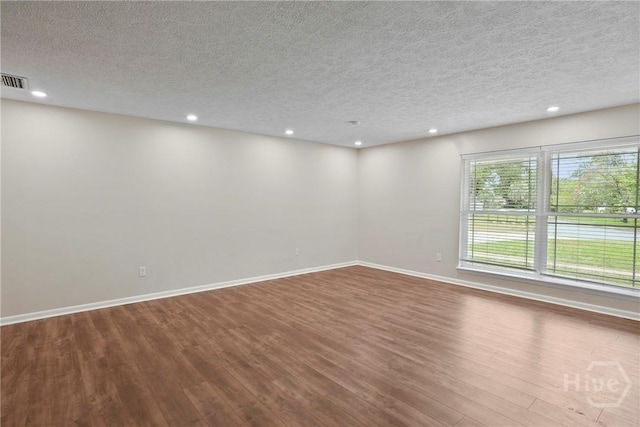 13609 Rockingham Ct, Savannah, GA 31419 - spare room with wood finished floors, a textured ceiling, and recessed lighting