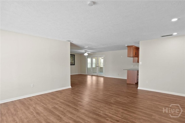13609 Rockingham Ct, Savannah, GA 31419 - unfurnished living room with a textured ceiling, dark wood-style floors, and ceiling fan