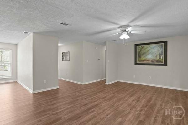 13609 Rockingham Ct, Savannah, GA 31419 - spare room featuring a textured ceiling, dark wood-type flooring, and a ceiling fan