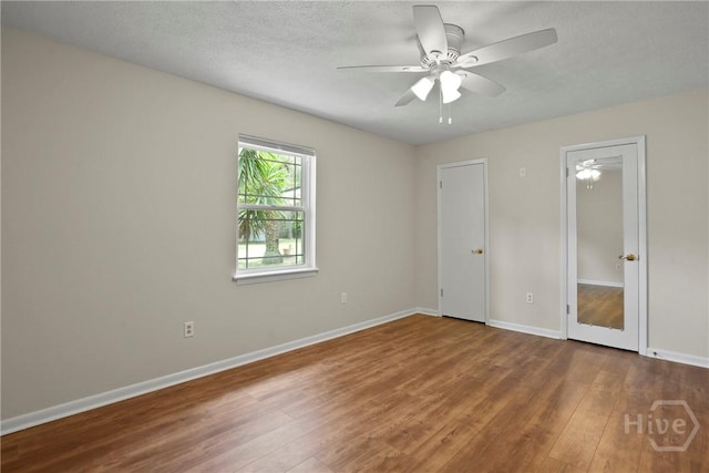 13609 Rockingham Ct, Savannah, GA 31419 - unfurnished bedroom with wood finished floors, a textured ceiling, and a ceiling fan
