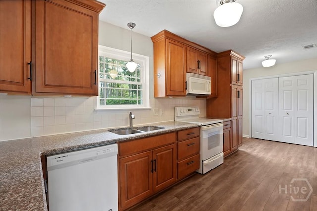 13609 Rockingham Ct, Savannah, GA 31419 - kitchen with white appliances, brown cabinetry, tasteful backsplash, dark wood finished floors, and hanging light fixtures