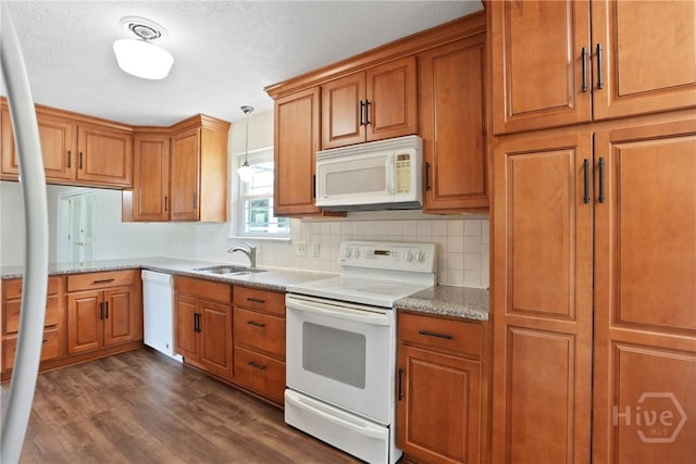 13609 Rockingham Ct, Savannah, GA 31419 - kitchen featuring white appliances, brown cabinets, dark wood-style floors, backsplash, and a textured ceiling