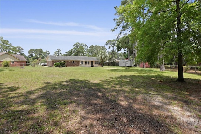 13609 Rockingham Ct, Savannah, GA 31419 - view of grassy yard with a storage unit