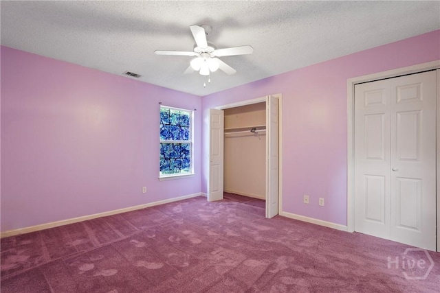 11 Gilliam Ave, Savannah, GA 31406 - unfurnished bedroom with two closets, carpet flooring, a textured ceiling, and a ceiling fan