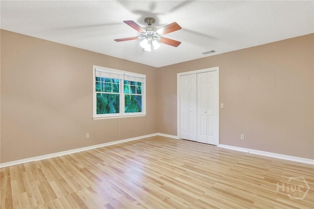 123 Companion Way, Savannah, GA 31419 - unfurnished bedroom featuring light wood-type flooring, a closet, ceiling fan, and a textured ceiling