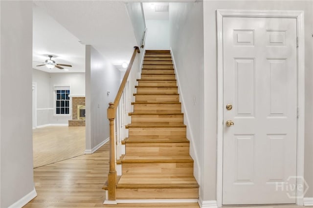 123 Companion Way, Savannah, GA 31419 - stairs featuring ceiling fan, wood finished floors, and a fireplace