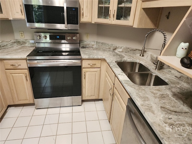 123 Companion Way, Savannah, GA 31419 - kitchen featuring stainless steel appliances, light tile patterned floors, glass insert cabinets, light brown cabinets, and light stone counters
