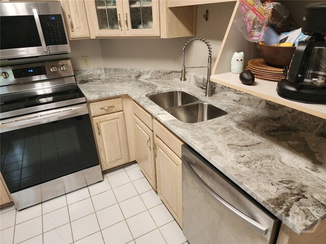123 Companion Way, Savannah, GA 31419 - kitchen featuring stainless steel appliances, light tile patterned flooring, light brown cabinets, glass insert cabinets, and light stone countertops
