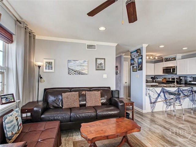 8 Silver Ave Unit 9, Tybee Island, GA 31328 - living area with a ceiling fan, crown molding, recessed lighting, and wood finished floors