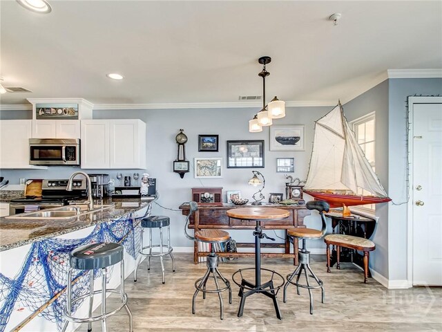 8 Silver Ave Unit 9, Tybee Island, GA 31328 - dining space featuring ornamental molding, light wood finished floors, and recessed lighting