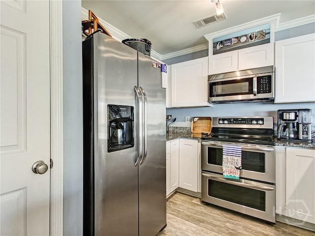 8 Silver Ave Unit 9, Tybee Island, GA 31328 - kitchen featuring stainless steel appliances, white cabinetry, crown molding, and dark stone counters