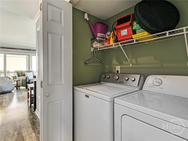 8 Silver Ave Unit 9, Tybee Island, GA 31328 - laundry area with washer and dryer and wood finished floors