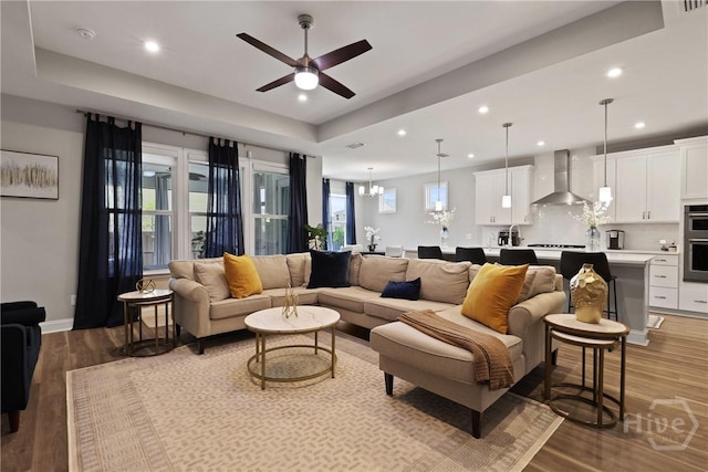 742 Longleaf Dr, Richmond Hill, GA 31324 - living area with wood finished floors, ceiling fan, recessed lighting, a chandelier, and a raised ceiling