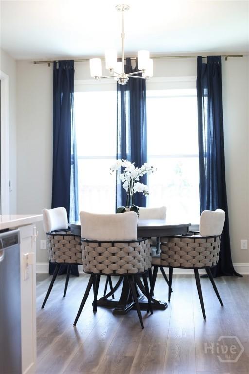 742 Longleaf Dr, Richmond Hill, GA 31324 - dining area featuring a chandelier and wood finished floors