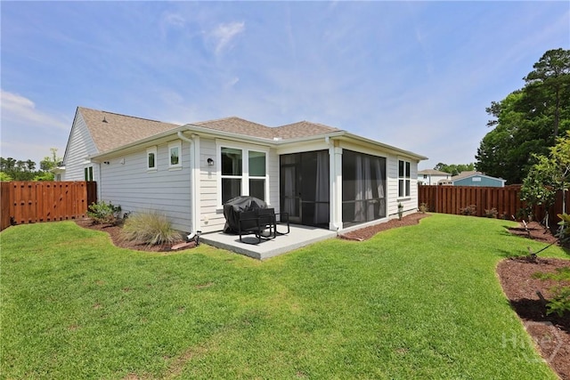 742 Longleaf Dr, Richmond Hill, GA 31324 - back of property with a fenced backyard, a sunroom, a patio, and roof with shingles