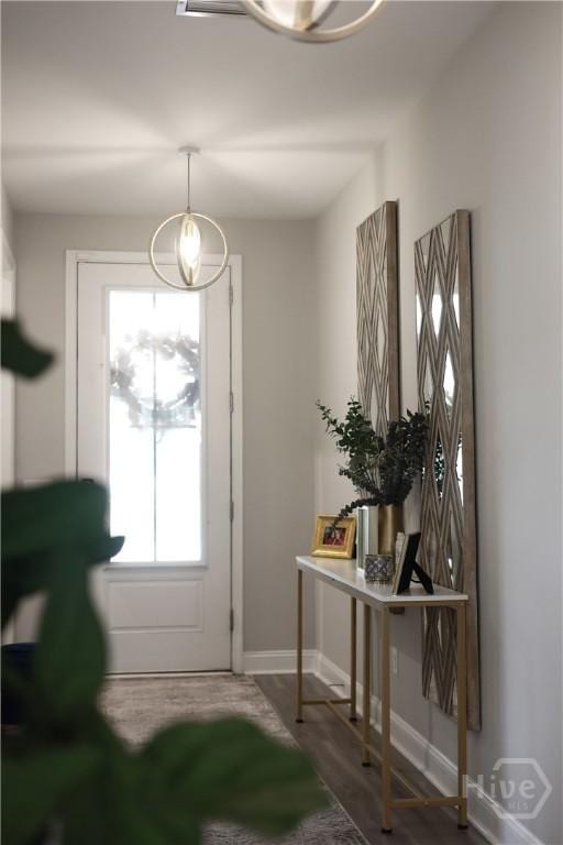 742 Longleaf Dr, Richmond Hill, GA 31324 - doorway featuring a chandelier and wood finished floors