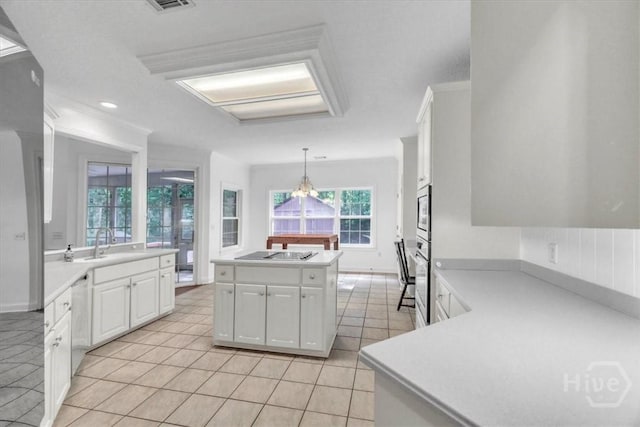 80 Windsong Dr, Richmond Hill, GA 31324 - kitchen featuring black electric cooktop, white cabinetry, light countertops, and light tile patterned flooring