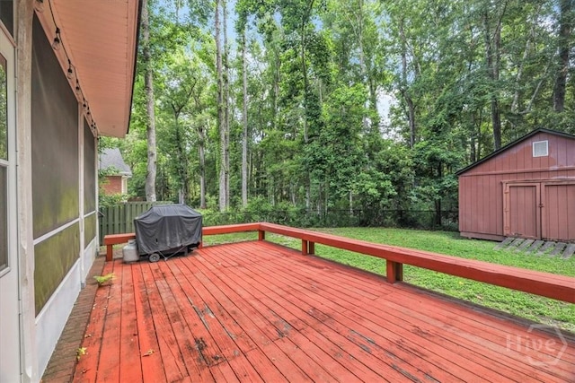 80 Windsong Dr, Richmond Hill, GA 31324 - deck with grilling area, a storage unit, a fenced backyard, and view of scattered trees