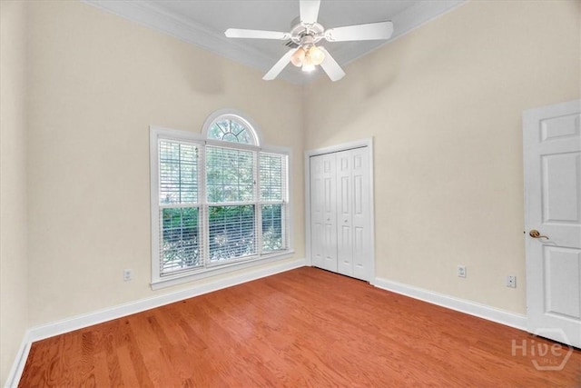 80 Windsong Dr, Richmond Hill, GA 31324 - unfurnished bedroom with wood finished floors, crown molding, a closet, and a ceiling fan