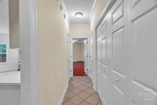 80 Windsong Dr, Richmond Hill, GA 31324 - hall with crown molding, light tile patterned floors, and a textured ceiling