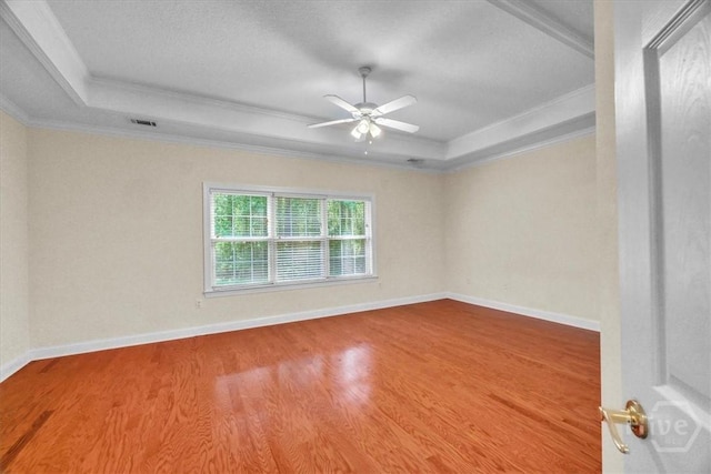 80 Windsong Dr, Richmond Hill, GA 31324 - spare room featuring a tray ceiling, ornamental molding, ceiling fan, and wood finished floors