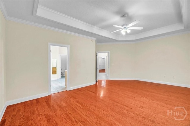 80 Windsong Dr, Richmond Hill, GA 31324 - unfurnished room featuring a raised ceiling, crown molding, a ceiling fan, and wood finished floors