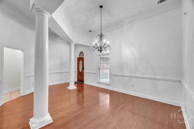 80 Windsong Dr, Richmond Hill, GA 31324 - unfurnished dining area featuring ornate columns, wood finished floors, and ornamental molding
