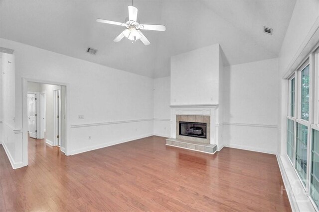 80 Windsong Dr, Richmond Hill, GA 31324 - unfurnished living room with high vaulted ceiling, a tile fireplace, wood finished floors, and a ceiling fan