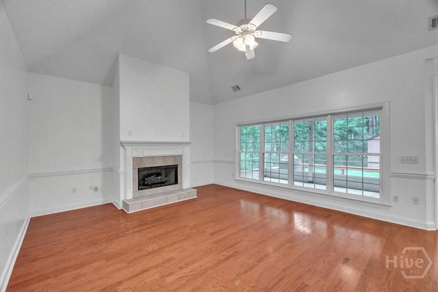 80 Windsong Dr, Richmond Hill, GA 31324 - unfurnished living room featuring high vaulted ceiling, a ceiling fan, a tiled fireplace, and wood finished floors