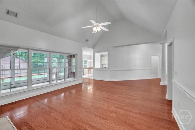 80 Windsong Dr, Richmond Hill, GA 31324 - unfurnished living room with high vaulted ceiling, ceiling fan, wood finished floors, and ornate columns
