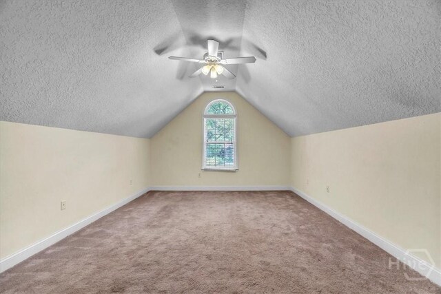 80 Windsong Dr, Richmond Hill, GA 31324 - bonus room featuring a textured ceiling, lofted ceiling, carpet floors, and ceiling fan