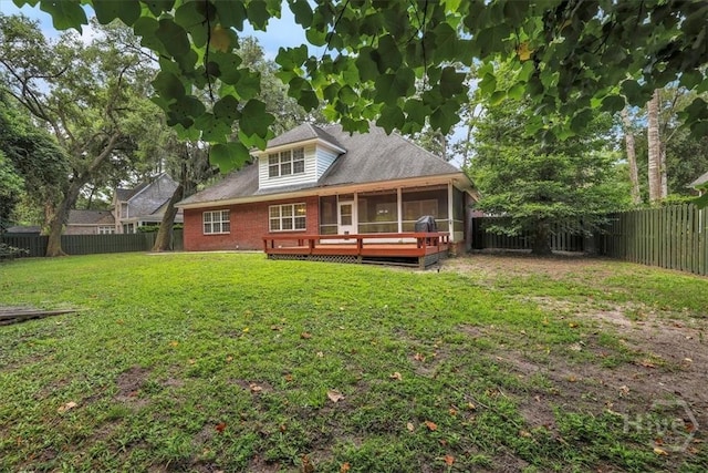 80 Windsong Dr, Richmond Hill, GA 31324 - back of house with a fenced backyard, a sunroom, a wooden deck, and brick siding