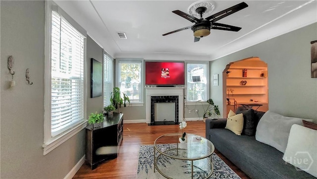 202 Columbus Dr, Savannah, GA 31405 - living room with wood finished floors, a ceiling fan, and a tile fireplace