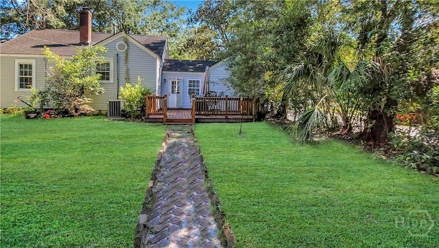 202 Columbus Dr, Savannah, GA 31405 - rear view of house with a deck, a yard, a chimney, and a shingled roof