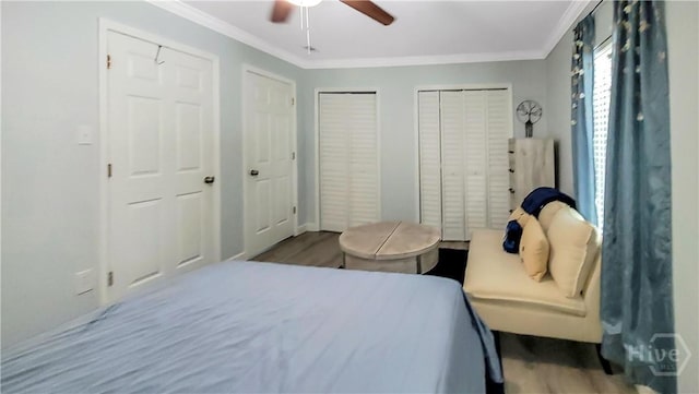 202 Columbus Dr, Savannah, GA 31405 - bedroom featuring two closets, ornamental molding, wood finished floors, and a ceiling fan