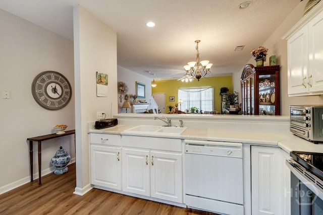 12 Crossing Dr, Richmond Hill, GA 31324 - kitchen with white dishwasher, a chandelier, light wood-style floors, light countertops, and white cabinetry