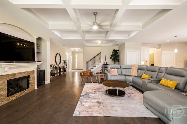 28 Misty Marsh Dr, Savannah, GA 31419 - living room featuring ceiling fan, coffered ceiling, dark wood-style floors, beam ceiling, and a stone fireplace