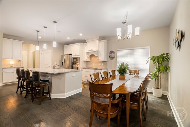 28 Misty Marsh Dr, Savannah, GA 31419 - dining room with a chandelier, dark wood finished floors, recessed lighting, and arched walkways