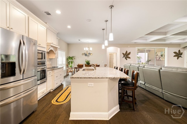 28 Misty Marsh Dr, Savannah, GA 31419 - kitchen with stainless steel appliances, recessed lighting, a breakfast bar area, an island with sink, and dark wood-style flooring