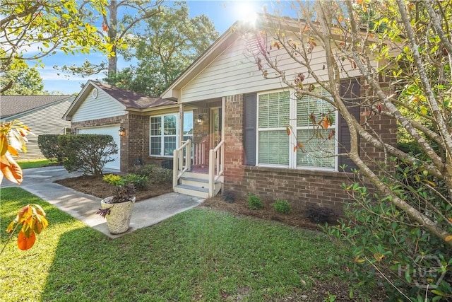 139 Crossover Ln, Savannah, GA 31410 - view of front facade featuring brick siding, a garage, and a front lawn