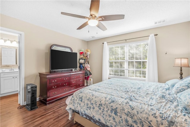 139 Crossover Ln, Savannah, GA 31410 - bedroom featuring wood finished floors, a ceiling fan, ensuite bath, and a textured ceiling