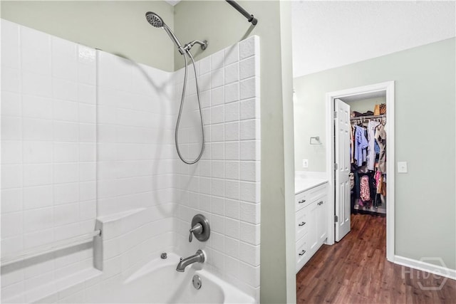 139 Crossover Ln, Savannah, GA 31410 - bathroom with shower / washtub combination, vanity, wood finished floors, and a walk in closet