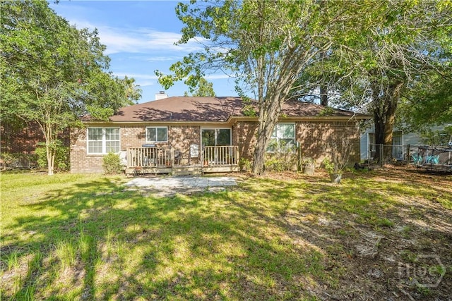 139 Crossover Ln, Savannah, GA 31410 - back of house featuring brick siding, a deck, and a chimney