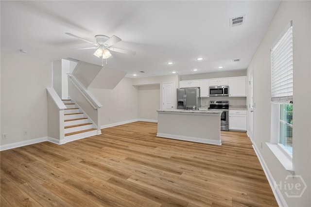 13 Abaco Ct, Savannah, GA 31419 - kitchen featuring appliances with stainless steel finishes, light wood finished floors, ceiling fan, white cabinets, and recessed lighting