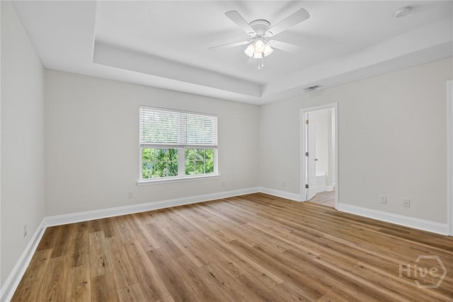 13 Abaco Ct, Savannah, GA 31419 - empty room featuring a raised ceiling, light wood-style flooring, a smoke detector, and ceiling fan