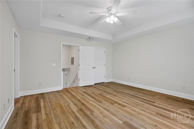 13 Abaco Ct, Savannah, GA 31419 - unfurnished bedroom with a raised ceiling, light wood finished floors, and ceiling fan