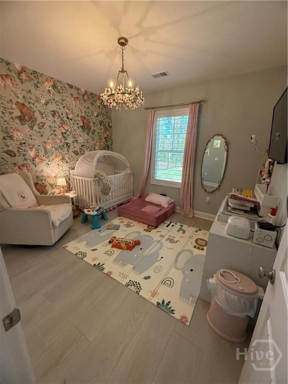 275 Heron Ct, Saint Marys, GA 31558 - bedroom with a chandelier and a nursery area