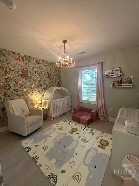 275 Heron Ct, Saint Marys, GA 31558 - bedroom with a chandelier and a crib
